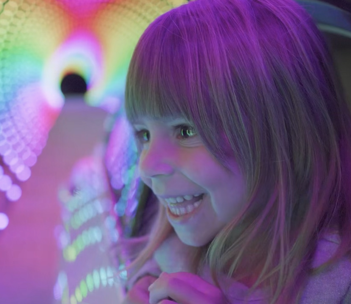 Family enjoying holiday light show from their vehicle